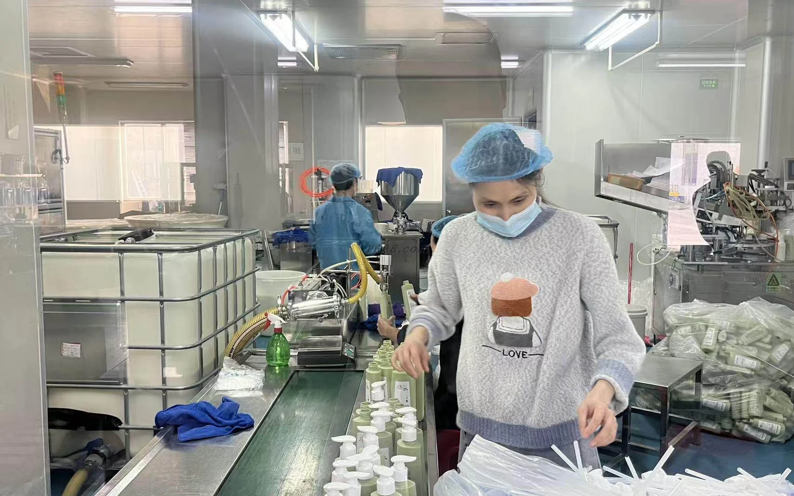 Cosmetics filling suite with production staff and packaging equipment